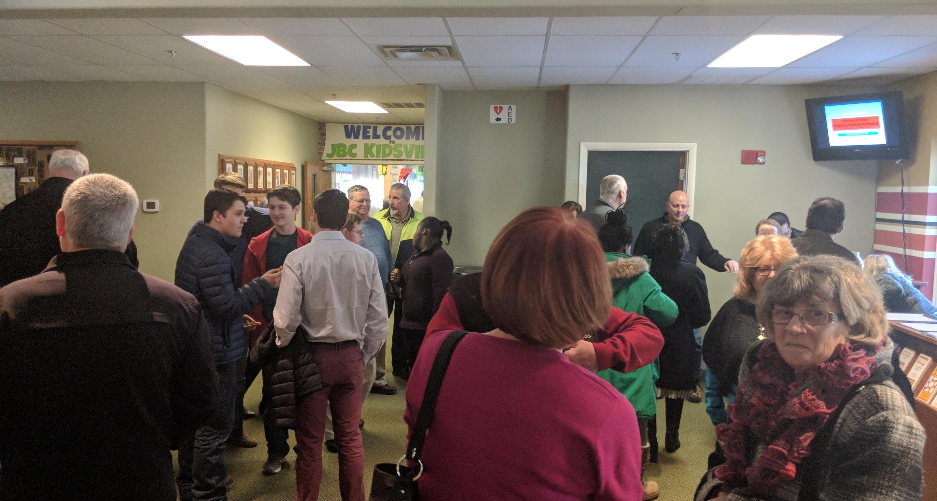 People connecting in the church lobby